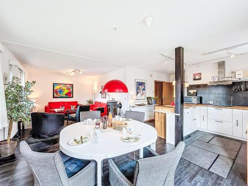 a kitchen and living room with a white table and chairs at Apartment Martin by Interhome in Frankenau