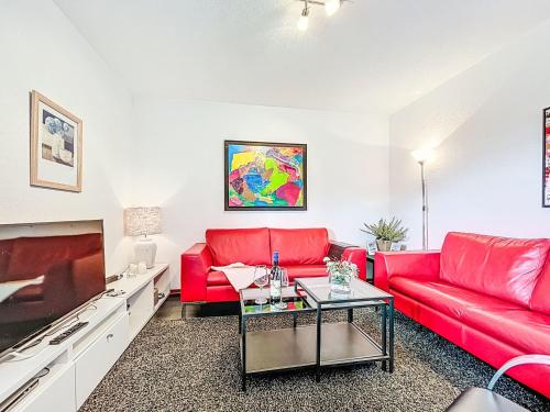 a living room with a red couch and a table at Apartment Martin by Interhome in Frankenau