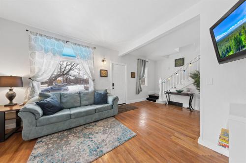 a living room with a couch and a tv at 3BR Home Across from Como Lake - Aspen in Saint Paul