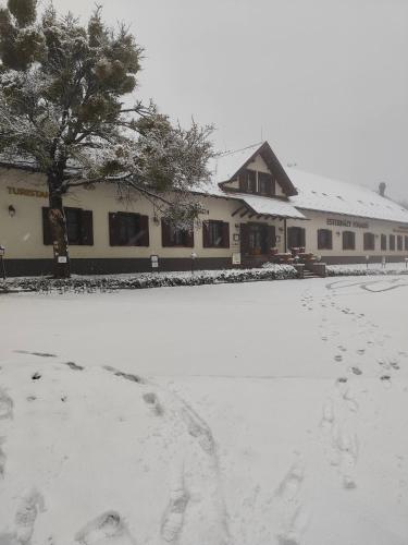 a building with a lot of snow in front of it at Esterházy Fogadó in Gánt