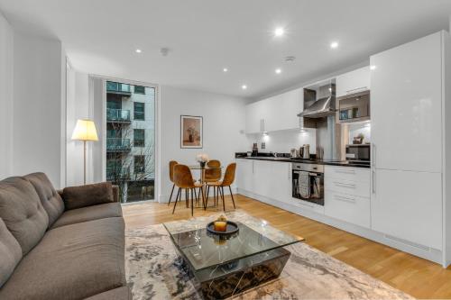 a living room with a couch and a table at MySquare Lanterns Way Apartments at Canary Wharf in London