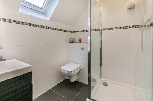 a bathroom with a toilet and a glass shower at 3 Bed in St. Ives oc-c30315 in Carbis Bay