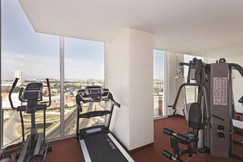 a gym with treadmills and ellipticals in a building at La Quinta by Wyndham Puebla Palmas Angelopolis in Puebla