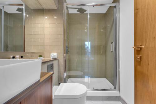 a bathroom with a toilet and a shower at Talisman & Duckman Tower at Canary Wharf by MySquare in London