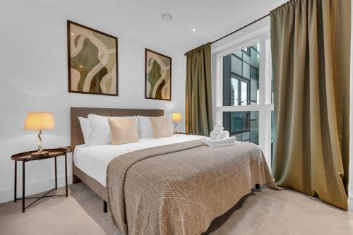 a bedroom with a bed and a large window at Talisman & Duckman Tower at Canary Wharf by MySquare in London