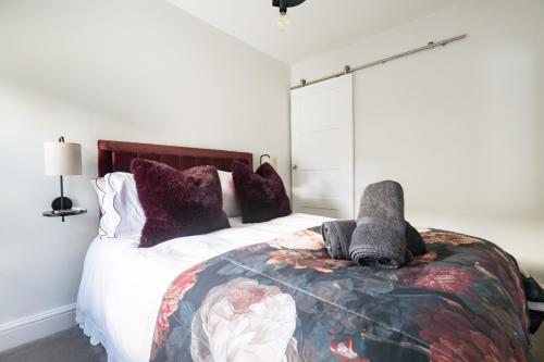 a bedroom with a bed with a stuffed animal on it at The Rosemont in Royal Tunbridge Wells