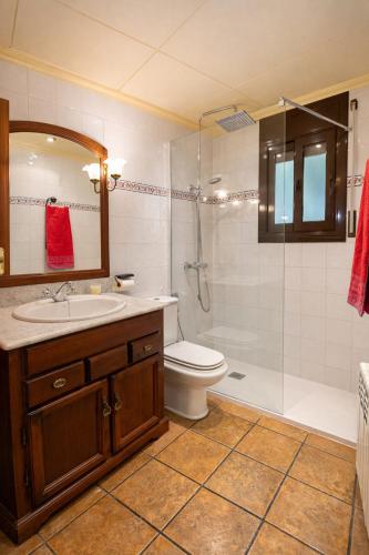 a bathroom with a toilet and a sink and a shower at Catalunya Casas Peaceful Perfection , only 30km from Barcelona! in Vacarisas