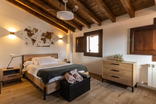 a bedroom with a large bed and a dresser at La casina de la alberca in La Alberca