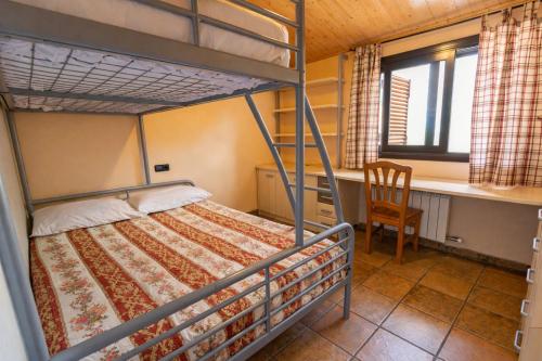 a bedroom with a bunk bed and a desk and a chair at Catalunya Casas Peaceful Perfection , only 30km from Barcelona! in Vacarisas