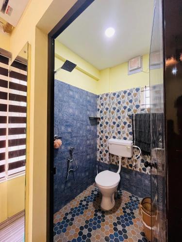 a bathroom with a toilet and a shower at panakkal tower in Guruvāyūr