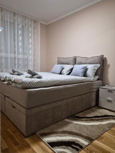 a bedroom with a large bed in a room at Apartman Mikulic 2 in Subotica