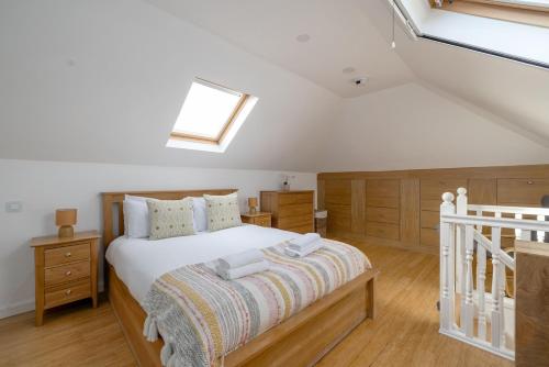 a bedroom with a bed and a skylight at Barnton Grove Getaway in Edinburgh