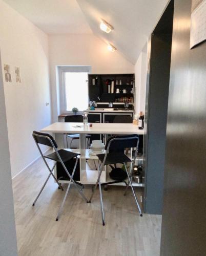 a kitchen with a table and chairs in a room at Ferienwohnung-Esel in Dreetz