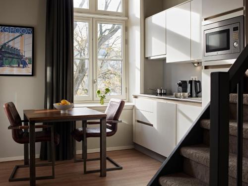 a small kitchen with a table and a window at YAYS Amsterdam Maritime by Numa in Amsterdam