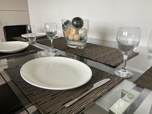 a table with a white plate and wine glasses at Ritson Wharf in Maryport