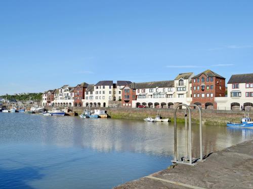 a view of a river with buildings and boats at Ritson Wharf in Maryport