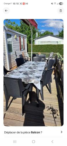 a table and chairs sitting on a deck at Mobil home in Biscarrosse