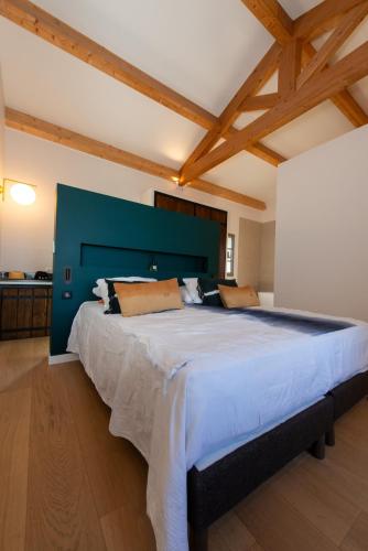 a large bedroom with a large bed with a blue headboard at Villa CAMILLE in Ersa