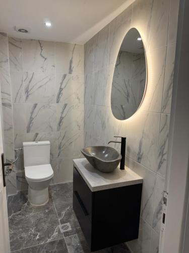 a bathroom with a sink and a mirror at 2 Bedroom, Sea Side Retreat Saronida in Saronida