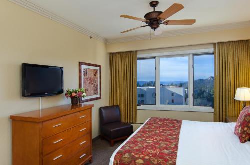 a bedroom with a bed and a television and a chair at Holiday Inn Club Vacations - Tahoe Ridge Resort in Stateline
