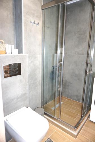 a shower stall in a bathroom with a toilet at The Little House Lamia - Fresh Central Apartment in Lamía