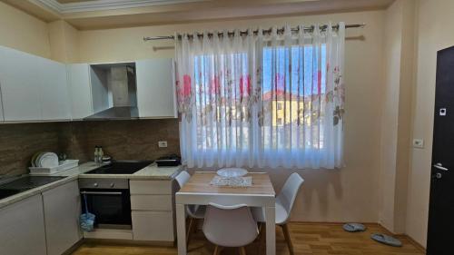 une petite cuisine avec une table et une fenêtre dans l'établissement Arditi's Guesthouse, à Shkodër