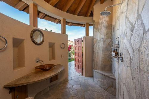 a bathroom with a sink and a shower at Villa Merion at PGA West | Grand Tuscan Estate in La Quinta