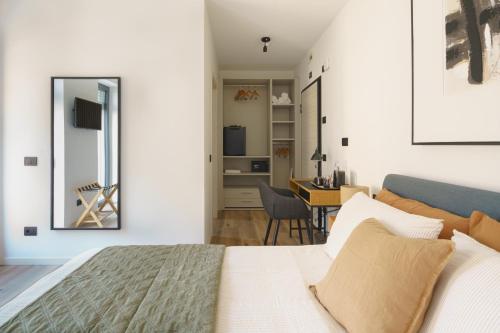 a bedroom with a bed and a mirror and a desk at CT Executive Rooms, Lake Como and Valtellina in Dubino