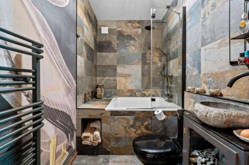 a bathroom with a sink and a toilet at Church conversion, Private garden, Parking in Cuckfield