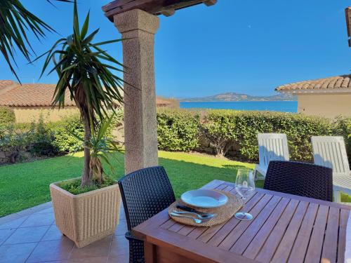 a wooden table with a plate of food on a patio at Villa Rosa in Cannigione