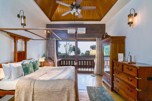 a bedroom with a bed and a ceiling fan at SaffronStays The Devrai by the Sea in Bhogwe