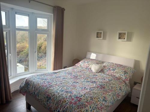 a bedroom with a bed with a stuffed animal on it at Stylish Holiday Home - Caherdaniel in Caherdaniel