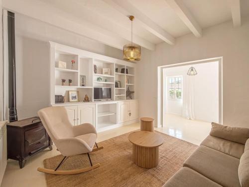 a living room with a couch and a chair at Can Borras by 3VILLAS in Llumesanas