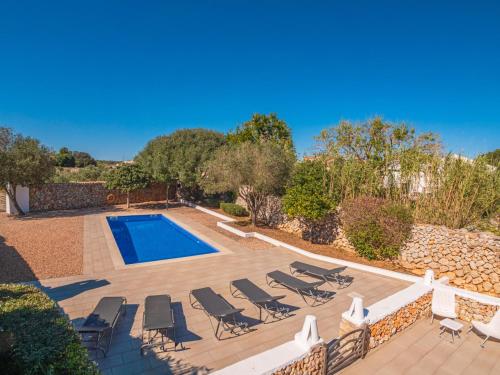 an image of a swimming pool with chaise lounges and a swimming pool at Can Borras by 3VILLAS in Llumesanas