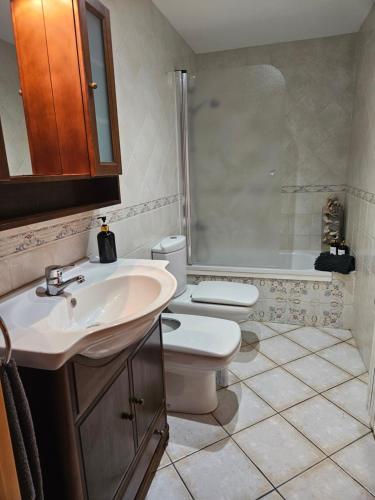 a bathroom with a toilet and a sink at Casa Maite in Palamós
