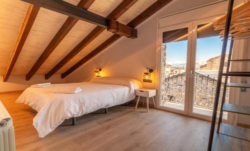 a bedroom with a bed and a large window at el Niuet All in All