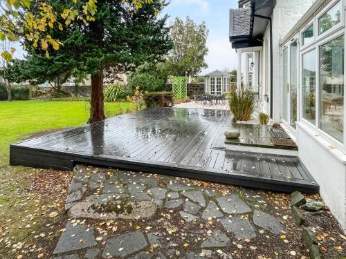 a house with a rain soaked patio at Springvale in Cardross