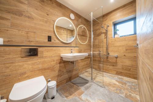 a bathroom with a toilet and a sink and a mirror at Elder howe in Penrith