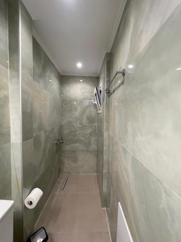 a bathroom with a shower and a toilet paper roll at Mare Studio by All Around in Heraklio