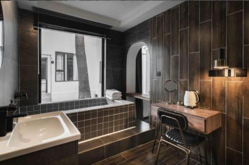 a bathroom with a sink and a mirror at My loft ChengDu in Chengdu