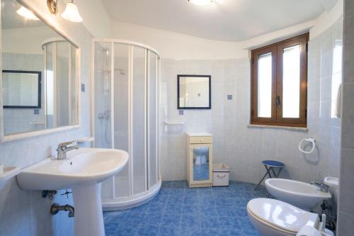 a bathroom with two sinks and a shower at CAPOVILLAS - Villa Laura with private pool in Vibo Valentia