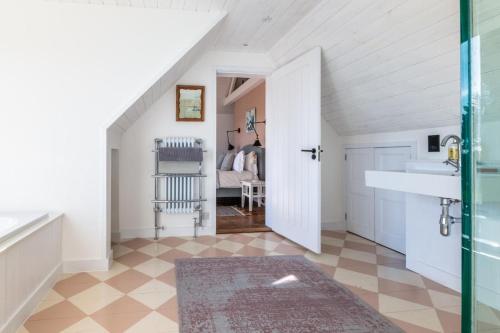 a bathroom with a sink and a bedroom at 5 Bed in Walberswick oc-lev in Walberswick