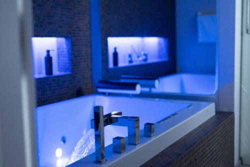 a bathroom with a tub with a sink and a mirror at Petra's Skyline in Suceava