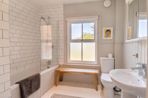 a bathroom with a toilet and a sink and a window at 4 Bed in Walberswick oc-hwfern in Walberswick