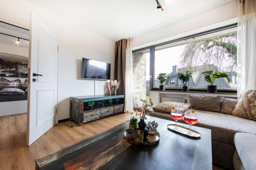 a living room with a couch and a table at Burgberg City Apartment in Daun