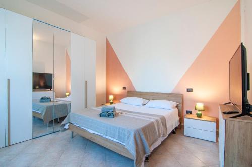 a bedroom with a large bed and a television at Emi&Marti House in Mozzecane