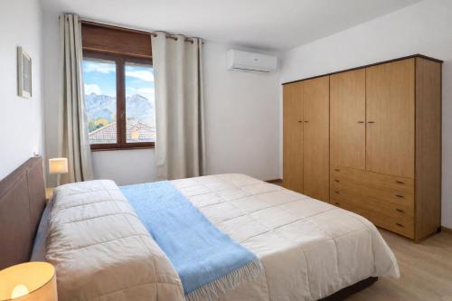 a bedroom with a large bed and a large window at Bella Vista Baveno in Baveno