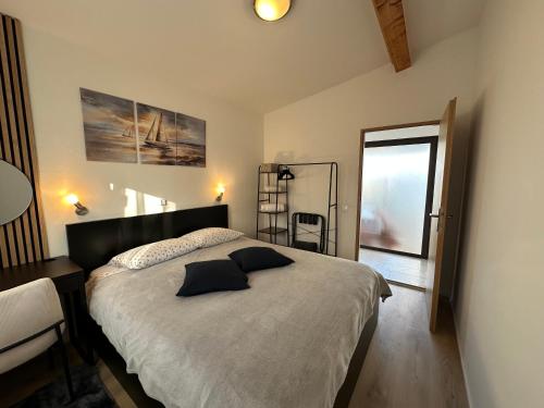 a bedroom with a bed and a table and a window at Holiday Home Kerniat in Pula