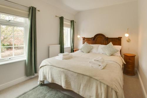 a bedroom with a large bed with towels on it at 2 Bed in Dersingham oc-2154 in Dersingham