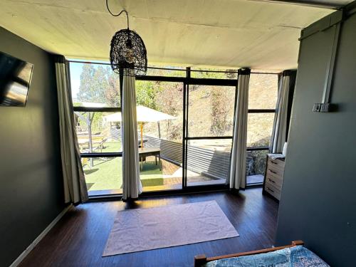 a living room with a large window with a view of a yard at Casa en Lota central con tinaja in Lota